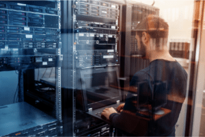 man working on computer in server reflection
